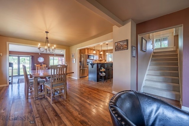 302 Ordway St S, Wilsall, MT 59086 - dining room with dark wood-style floors, a chandelier, and stairway