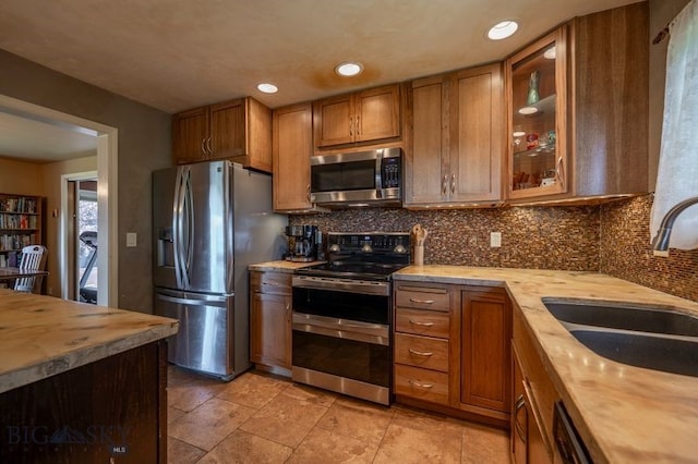 302 Ordway St S, Wilsall, MT 59086 - kitchen featuring stainless steel appliances, brown cabinetry, decorative backsplash, and recessed lighting