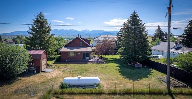 302 Ordway St S, Wilsall, MT 59086 - view of yard featuring a deck with mountain view and a storage shed