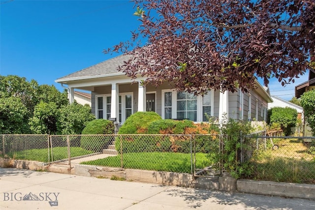 221 E Front, Butte, MT 59701 - view of front of property with covered porch, a fenced front yard, and a shingled roof
