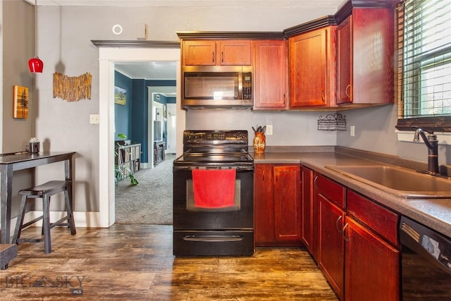 221 E Front, Butte, MT 59701 - kitchen featuring black appliances, dark wood finished floors, dark brown cabinets, and dark countertops