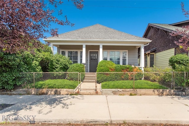 221 E Front, Butte, MT 59701 - bungalow-style house featuring a porch, a fenced front yard, a shingled roof, and a gate
