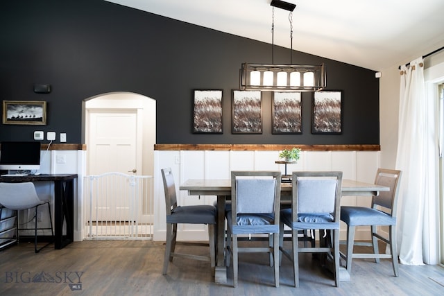 138 E Shade Tree Ln, Manhattan, MT 59741 - dining room featuring lofted ceiling, arched walkways, and wood finished floors
