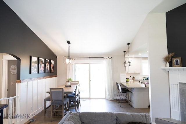 138 E Shade Tree Ln, Manhattan, MT 59741 - dining area featuring arched walkways, wood finished floors, and high vaulted ceiling