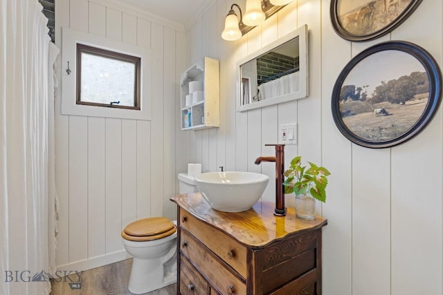 718 W Front, Livingston, MT 59047 - bathroom with vanity, wood finished floors, ornamental molding, and a shower with shower curtain