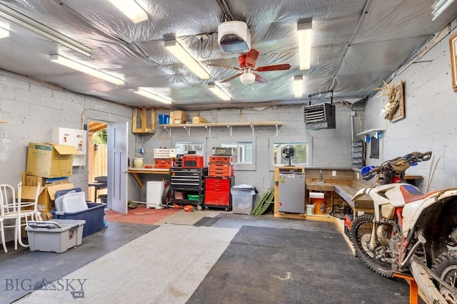 718 W Front, Livingston, MT 59047 - garage with a garage door opener, a workshop area, concrete block wall, a heating unit, and refrigerator