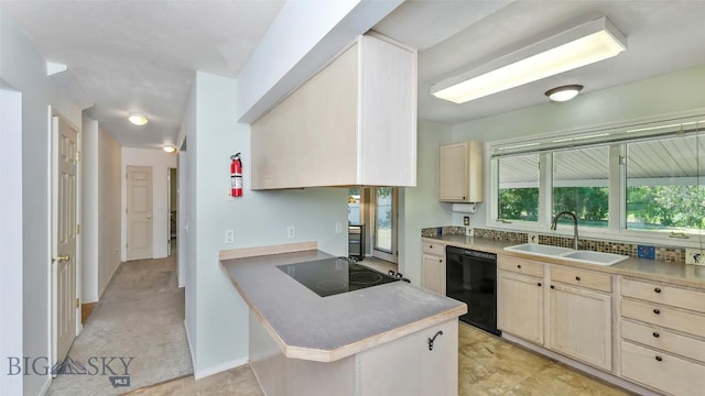 1008 E Missoula, Belgrade, MT 59714 - kitchen with black appliances, light brown cabinets, a peninsula, and cream cabinets