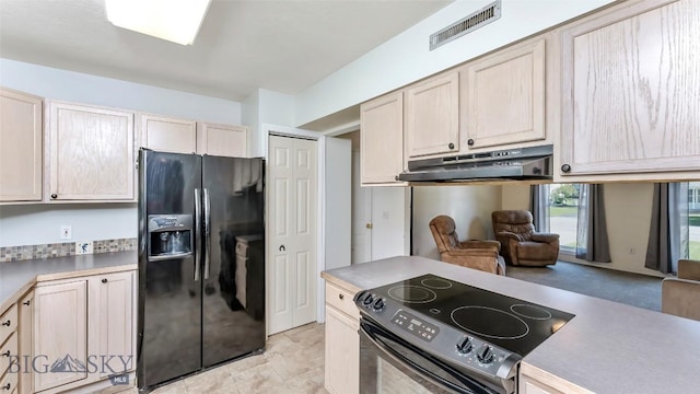 1008 E Missoula, Belgrade, MT 59714 - kitchen with black fridge, range with electric cooktop, under cabinet range hood, and light countertops