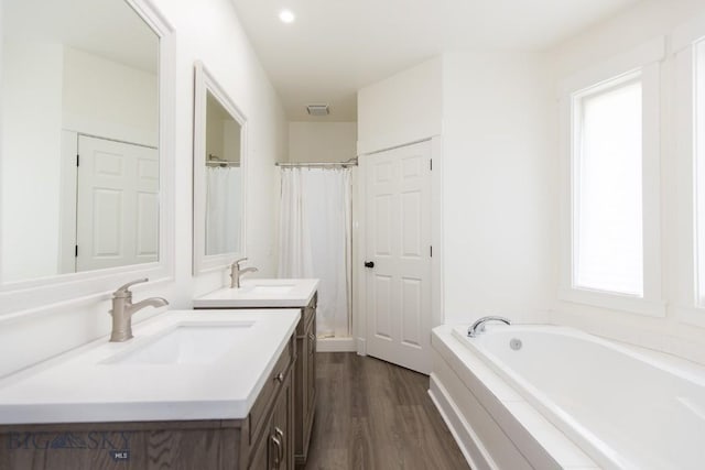 894 Rogers, Bozeman, MT 59718 - bathroom featuring double vanity, wood finished floors, a garden tub, and a shower with curtain