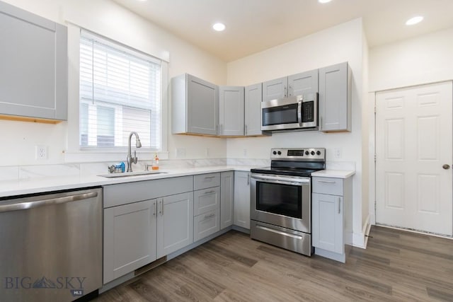 894 Rogers, Bozeman, MT 59718 - kitchen with stainless steel appliances, gray cabinets, light countertops, wood finished floors, and recessed lighting