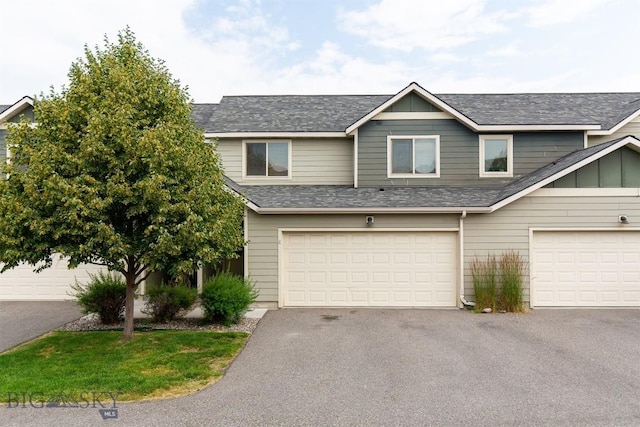 86 Tail Feather Unit C, Bozeman, MT 59718 - view of front of home featuring roof with shingles, driveway, board and batten siding, and a garage