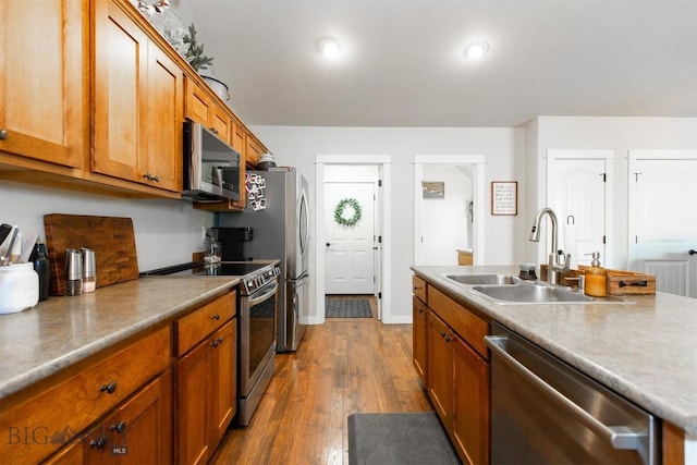 86 Tail Feather Unit C, Bozeman, MT 59718 - kitchen featuring stainless steel appliances, dark wood finished floors, and brown cabinets