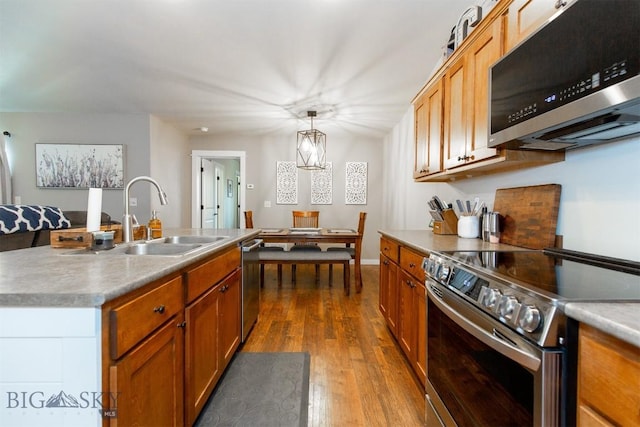 86 Tail Feather Unit C, Bozeman, MT 59718 - kitchen with stainless steel appliances, dark wood-type flooring, pendant lighting, and brown cabinets