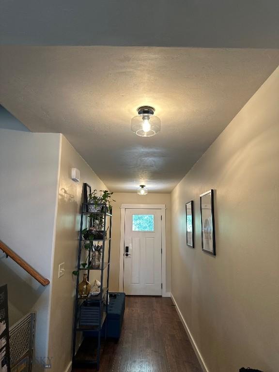 86 Tail Feather Unit C, Bozeman, MT 59718 - doorway to outside featuring dark wood-style flooring and baseboards