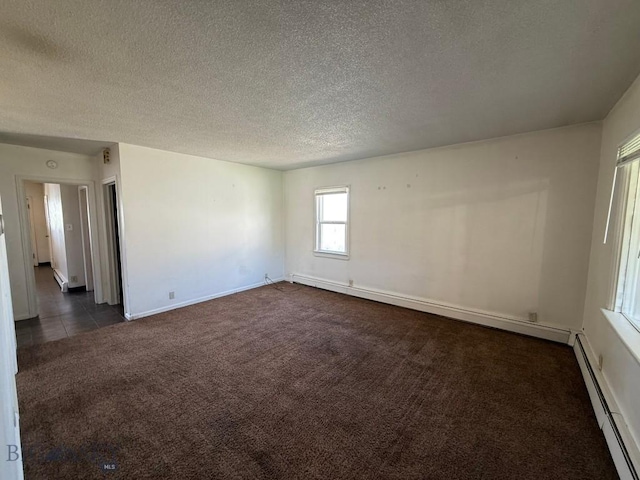 1915 S Montana, Butte, MT 59701 - empty room with dark colored carpet, a baseboard heating unit, and a textured ceiling