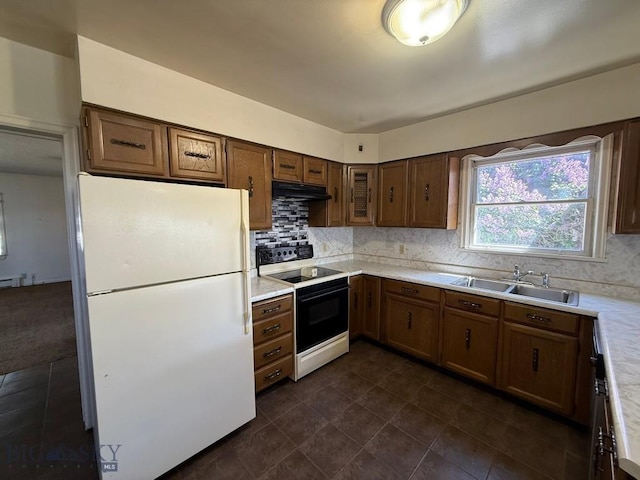 1915 S Montana, Butte, MT 59701 - kitchen featuring freestanding refrigerator, range with electric cooktop, light countertops, decorative backsplash, and under cabinet range hood