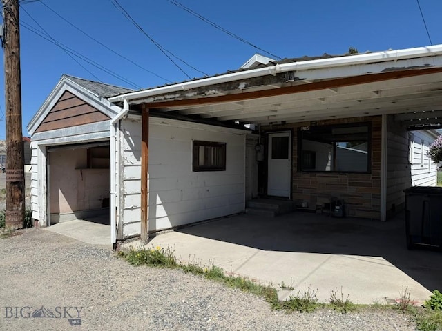 1915 S Montana, Butte, MT 59701 - view of front of property with driveway, entry steps, a detached garage, and a carport