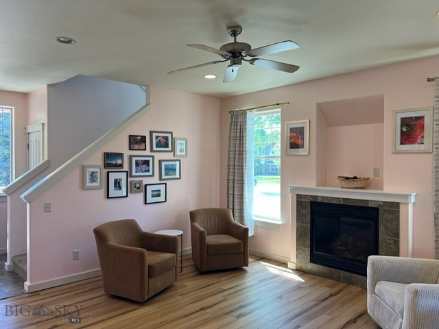 3885 Equestrian Ln, Bozeman, MT 59718 - living room with light wood-style floors, stairs, a fireplace, a ceiling fan, and recessed lighting