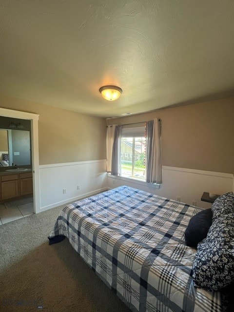 3885 Equestrian Ln, Bozeman, MT 59718 - carpeted bedroom with wainscoting and a sink