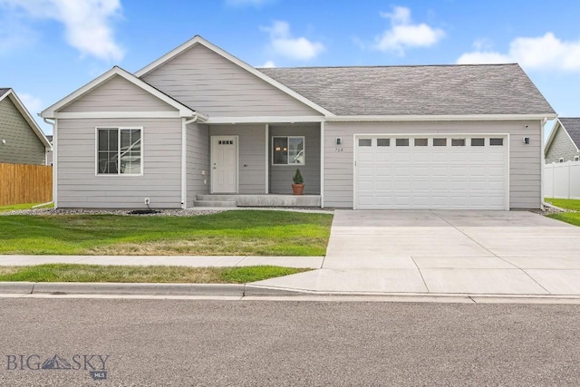708 Pierre St, Belgrade, MT 59714 - view of front of home with driveway, a garage, and a porch