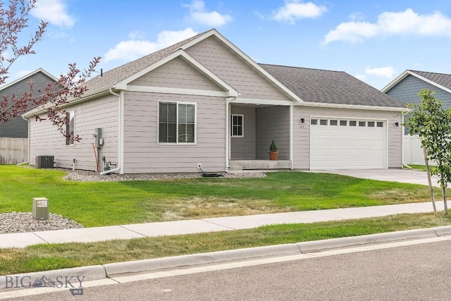 708 Pierre St, Belgrade, MT 59714 - ranch-style house with an attached garage, concrete driveway, a front lawn, and a shingled roof