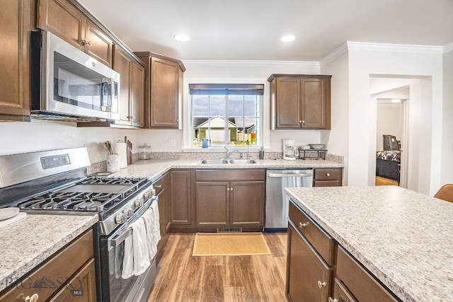 708 Pierre St, Belgrade, MT 59714 - kitchen with appliances with stainless steel finishes, light wood-type flooring, crown molding, light countertops, and recessed lighting