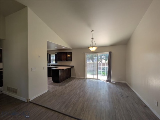 477 W River Rock, Belgrade, MT 59714 - kitchen with dark wood-style floors, open floor plan, dark brown cabinets, vaulted ceiling, and decorative light fixtures