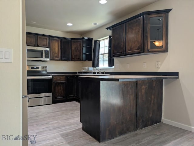 477 W River Rock, Belgrade, MT 59714 - kitchen featuring appliances with stainless steel finishes, dark brown cabinets, light wood-type flooring, open shelves, and recessed lighting