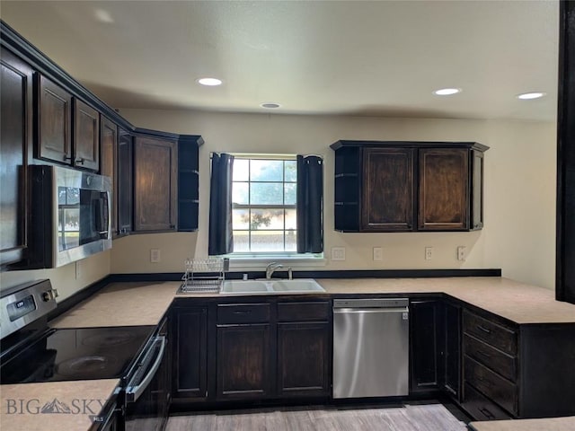 477 W River Rock, Belgrade, MT 59714 - kitchen featuring stainless steel appliances, a peninsula, light countertops, light wood finished floors, and recessed lighting