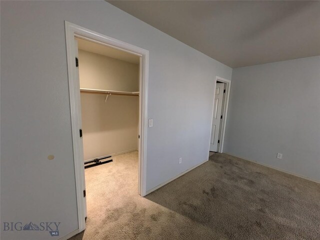 477 W River Rock, Belgrade, MT 59714 - unfurnished bedroom featuring carpet flooring and a walk in closet