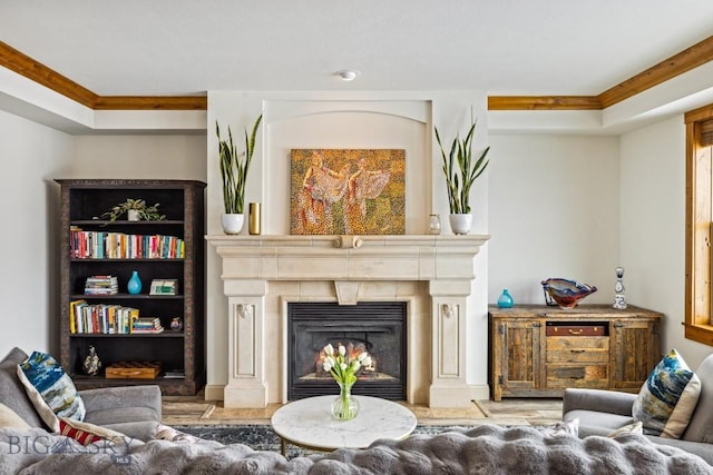 3609 Fieldstone W, Bozeman, MT 59715 - living area featuring wood finished floors, a lit fireplace, and crown molding