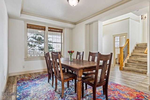 3609 Fieldstone W, Bozeman, MT 59715 - dining room featuring healthy amount of natural light, wood finished floors, stairs, and ornamental molding