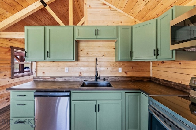 209 W Madison St, Virginia City, MT 59755 - kitchen with appliances with stainless steel finishes, wooden ceiling, wooden walls, and green cabinets