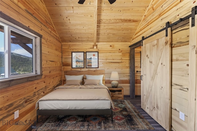 209 W Madison St, Virginia City, MT 59755 - bedroom featuring lofted ceiling, a barn door, wood walls, wood ceiling, and a ceiling fan