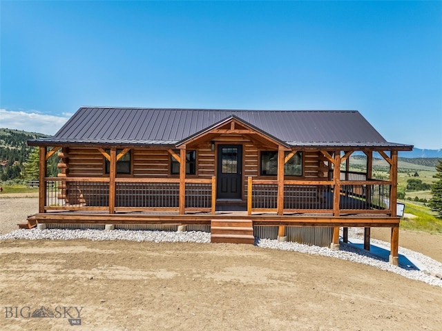 209 W Madison St, Virginia City, MT 59755 - log-style house featuring a metal roof, log exterior, and a porch