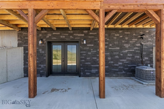 209 W Madison St, Virginia City, MT 59755 - doorway to property with french doors and stone siding