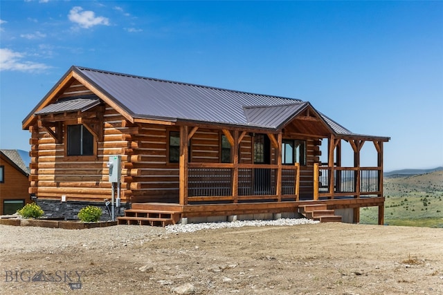 209 W Madison St, Virginia City, MT 59755 - view of front of home featuring log siding, a porch, and a metal roof