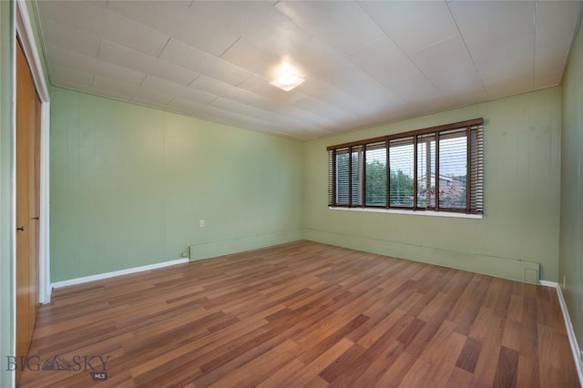 815 N Grand, Bozeman, MT 59715 - spare room with wood finished floors and baseboards