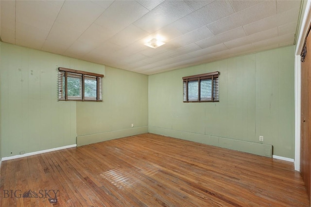815 N Grand, Bozeman, MT 59715 - spare room with plenty of natural light, hardwood / wood-style flooring, and wooden walls
