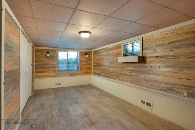 815 N Grand, Bozeman, MT 59715 - spare room with wood walls, wood finished floors, and a paneled ceiling