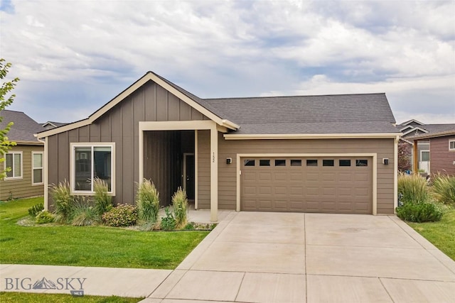 152 Goldcrest Ln, Bozeman, MT 59715 - view of front of home featuring board and batten siding, a front yard, a garage, and driveway