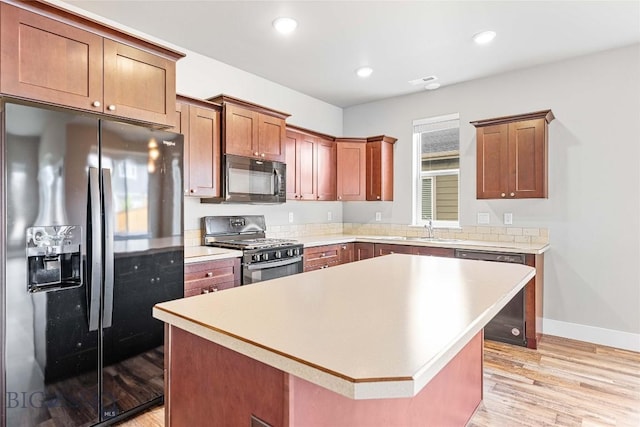 152 Goldcrest Ln, Bozeman, MT 59715 - kitchen featuring refrigerator with ice dispenser, black microwave, gas stove, dishwasher, and light wood-type flooring