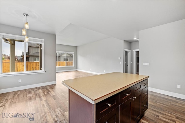 152 Goldcrest Ln, Bozeman, MT 59715 - kitchen featuring wood finished floors, decorative light fixtures, light countertops, and a center island