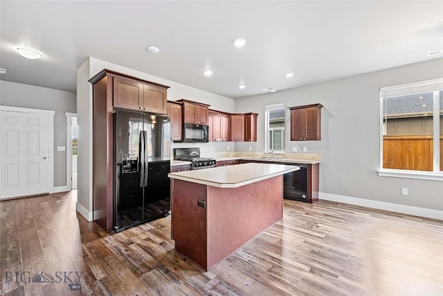 152 Goldcrest Ln, Bozeman, MT 59715 - kitchen featuring black appliances, a kitchen island, wood finished floors, light countertops, and recessed lighting