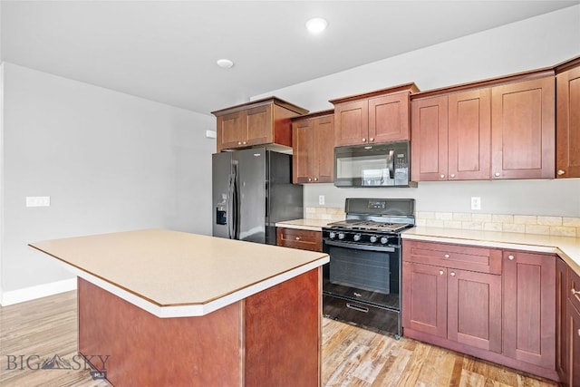 152 Goldcrest Ln, Bozeman, MT 59715 - kitchen featuring black appliances, light wood-style flooring, light countertops, and recessed lighting