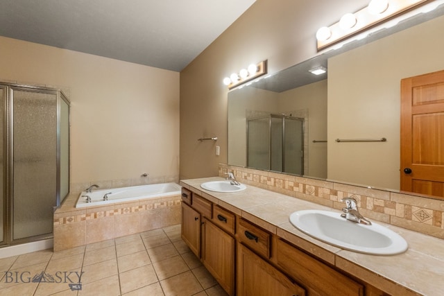 3300 E Graf Unit 26, Bozeman, MT 59715 - bathroom featuring a stall shower, double vanity, a garden tub, tile patterned flooring, and decorative backsplash