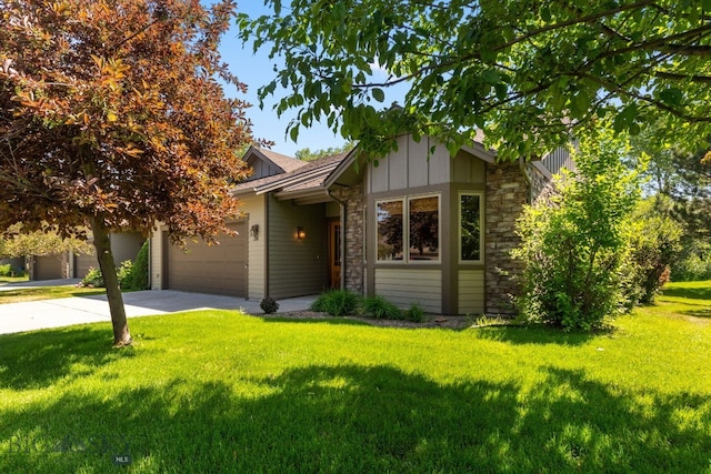 3300 E Graf Unit 26, Bozeman, MT 59715 - view of front of home with stone siding, an attached garage, board and batten siding, driveway, and a front lawn