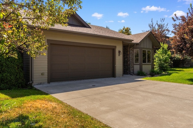 3300 E Graf Unit 26, Bozeman, MT 59715 - view of front of house featuring driveway, a front yard, a garage, and board and batten siding