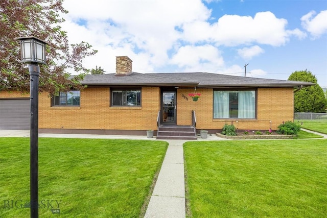 3011 Kossuth, Butte, MT 59701 - view of front of home featuring a chimney, brick siding, and a garage