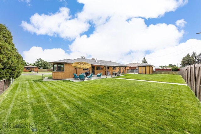 3011 Kossuth, Butte, MT 59701 - rear view of house featuring a patio, a storage shed, a fenced backyard, and brick siding